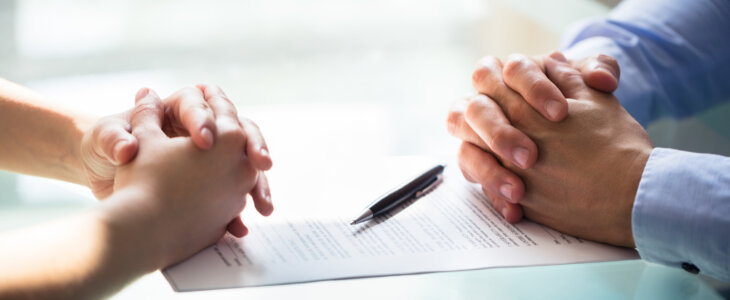 Close-up Of Two people Hand With Document On Desk. legal separation