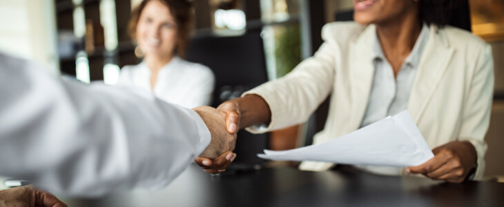 Business woman making plans with somebody, shaking hands.