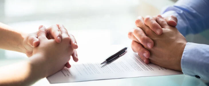 Close-up Of Two people Hand With Document On Desk. legal separation